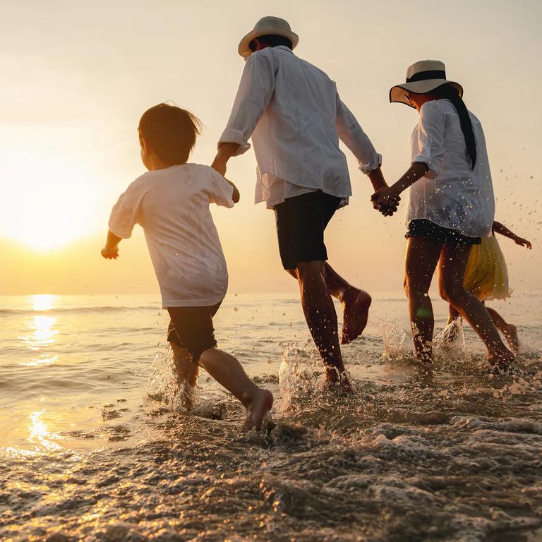 Happy asian family at consisting father, mother,son and daughter having fun playing beach in summer vacation on the beach.Happy family and vacations concept.  