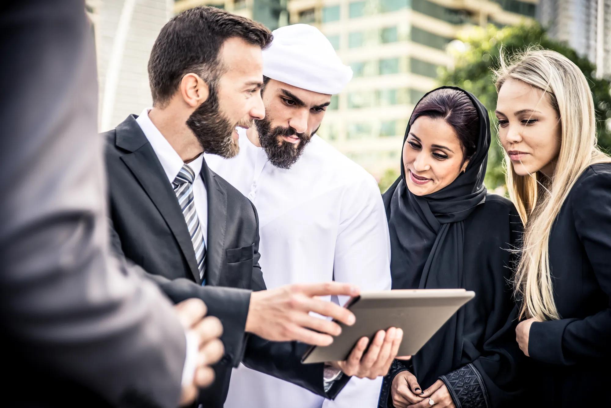 Arabic and western business people speaking about investments
